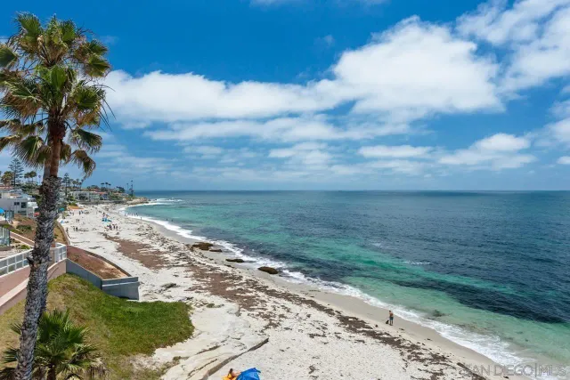 a aerial view of a brick building next to a yard