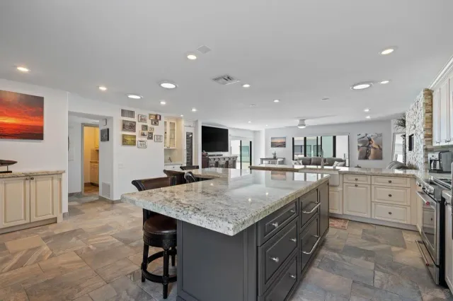 a kitchen with sink stove and cabinets