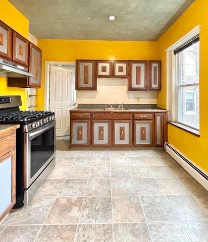 a kitchen with stainless steel appliances granite countertop a door and a refrigerator