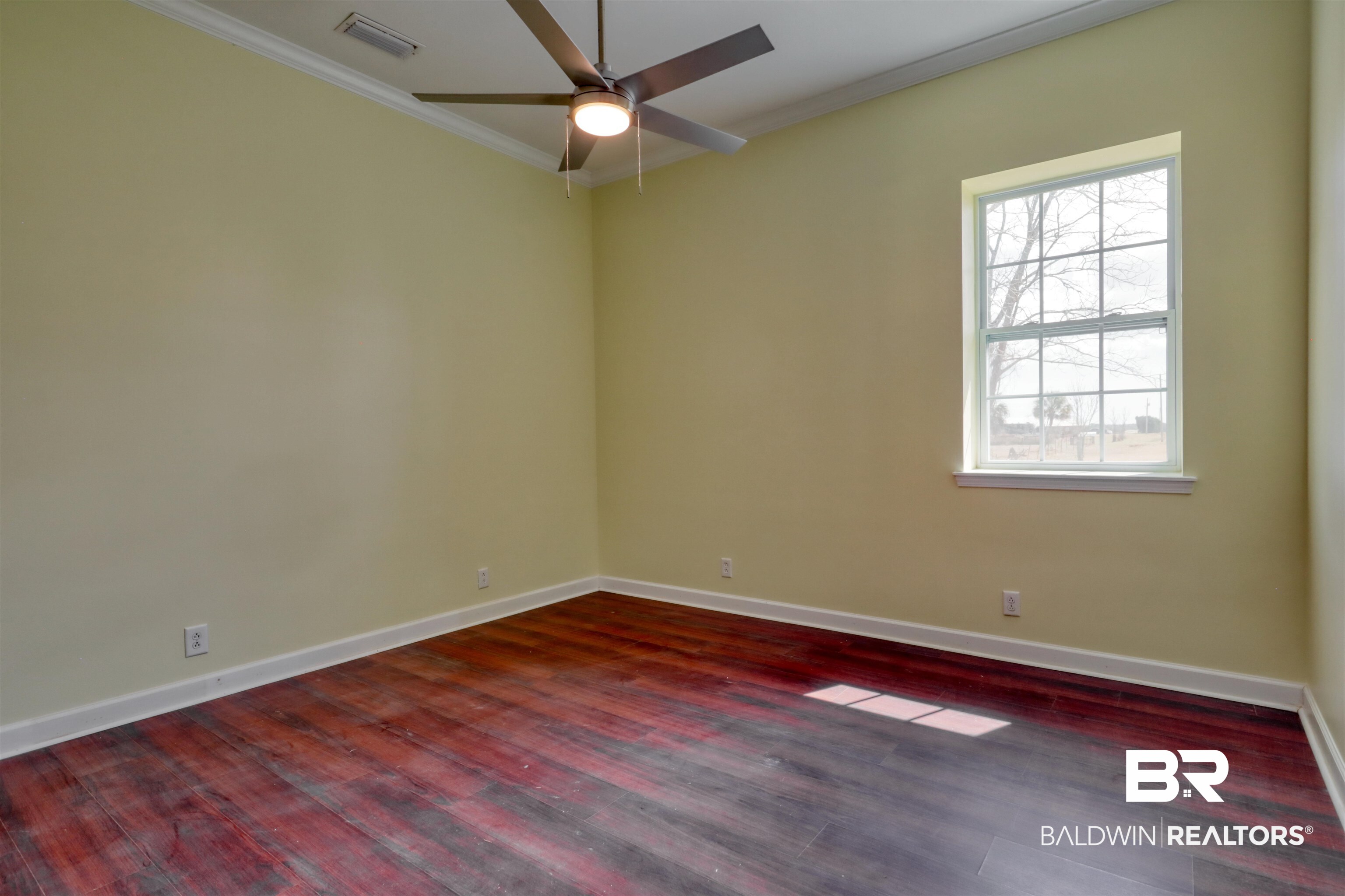 28461 Gardner Road Elberta, AL 36530 - Photo 19 of 46 Empty room with ornamental molding, dark wood-style floors, and a ceiling fan