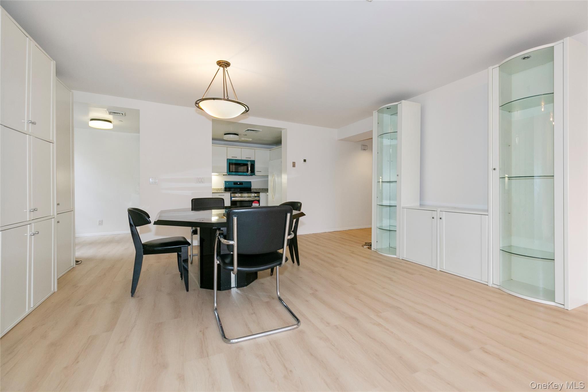 100 Cutter Mill Road, Unit 2C Great Neck, NY 11021 - Photo 11 of 29 a view of a dining room with furniture window and wooden floor