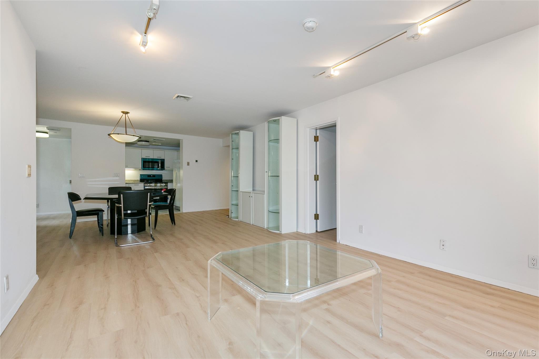 100 Cutter Mill Road, Unit 2C Great Neck, NY 11021 - Photo 14 of 29 a view of a room with furniture and wooden floor