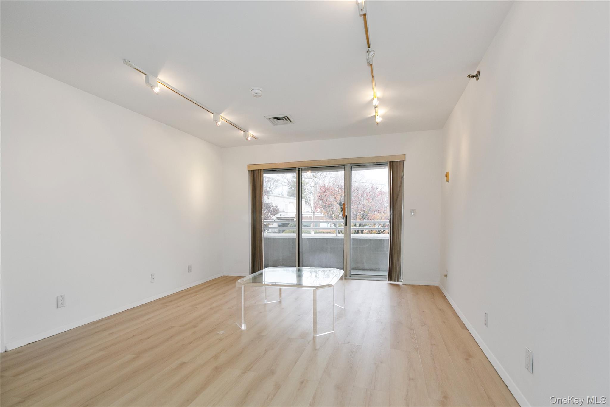 100 Cutter Mill Road, Unit 2C Great Neck, NY 11021 - Photo 24 of 29 a view of empty room with wooden floor and fan
