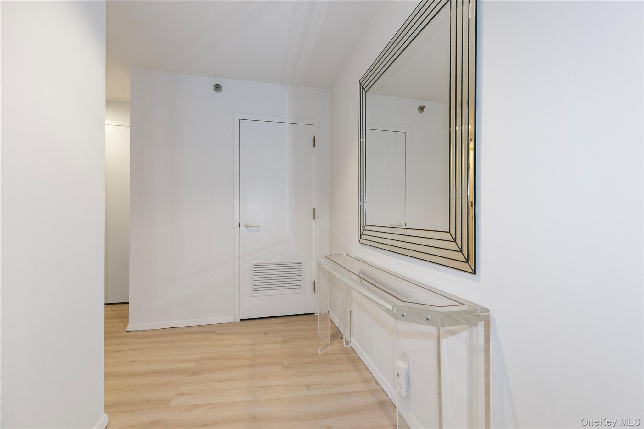 100 Cutter Mill Road, Unit 2C Great Neck, NY 11021 - Photo 8 of 29 a view of a hallway with front door