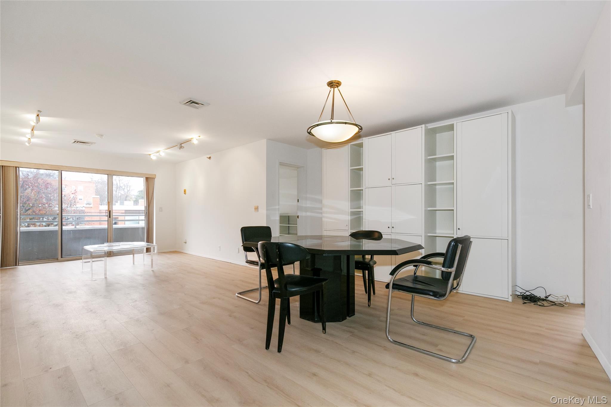 100 Cutter Mill Road, Unit 2C Great Neck, NY 11021 - Photo 10 of 29 a view of a dining room with furniture and wooden floor