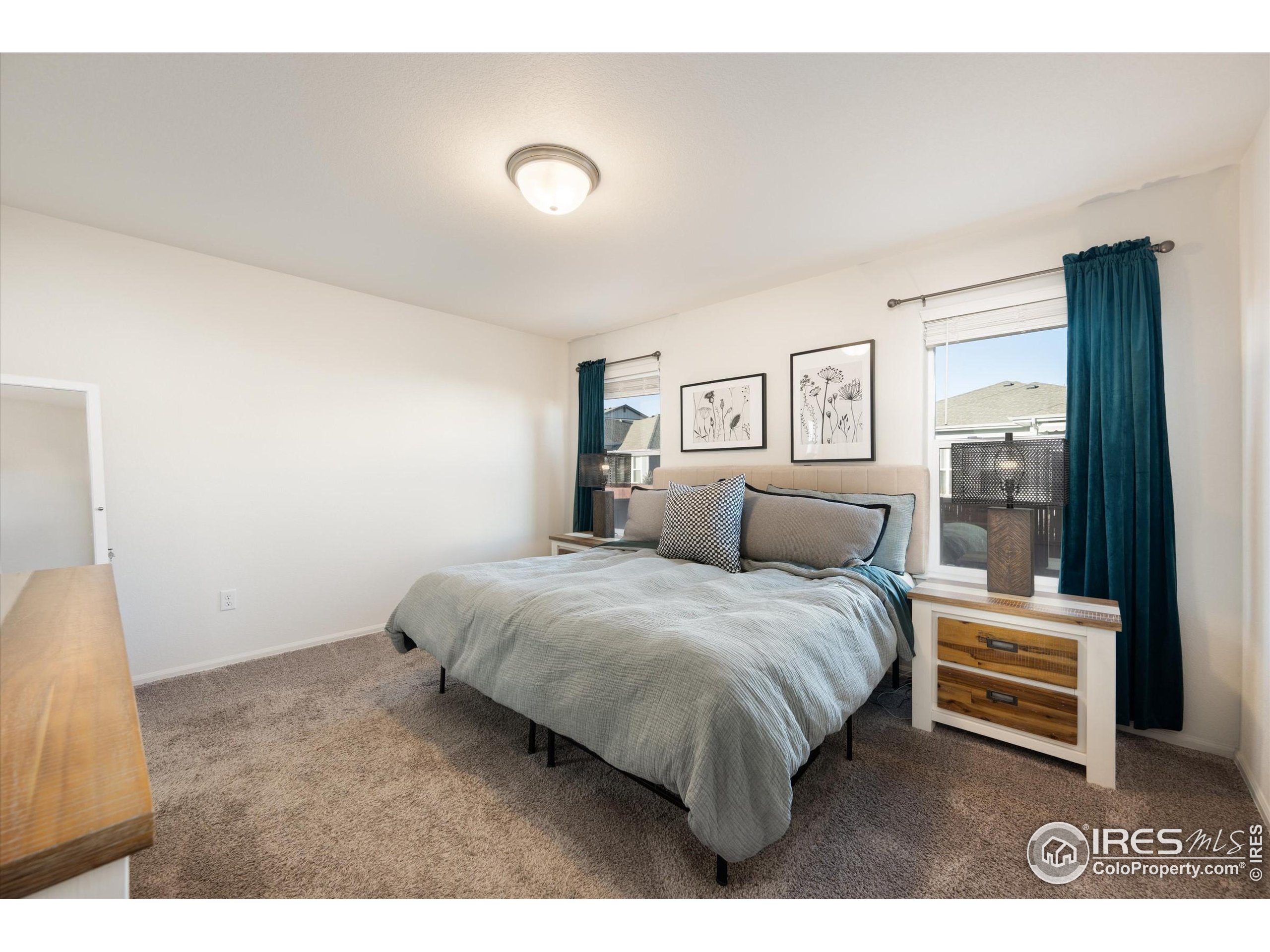 1995 Thundercloud Drive Windsor, CO 80550 - Photo 11 of 36 a spacious bedroom with a bed and a view of kitchen