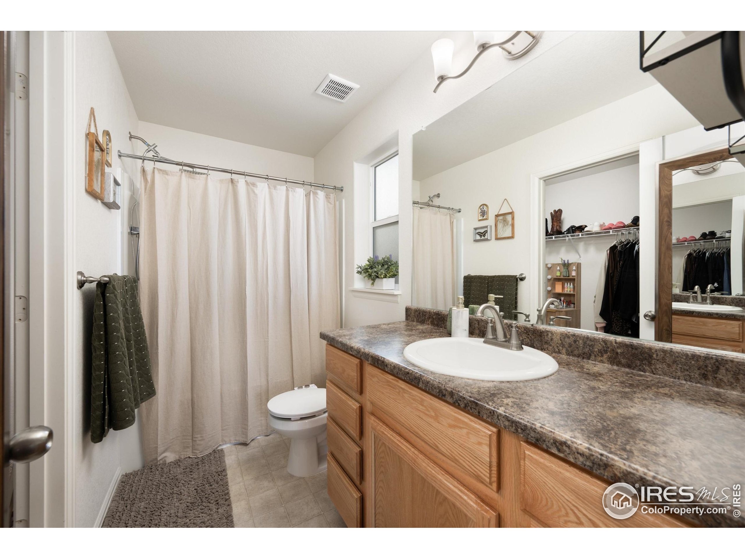 1995 Thundercloud Drive Windsor, CO 80550 - Photo 12 of 36 a bathroom with a granite countertop sink toilet and shower