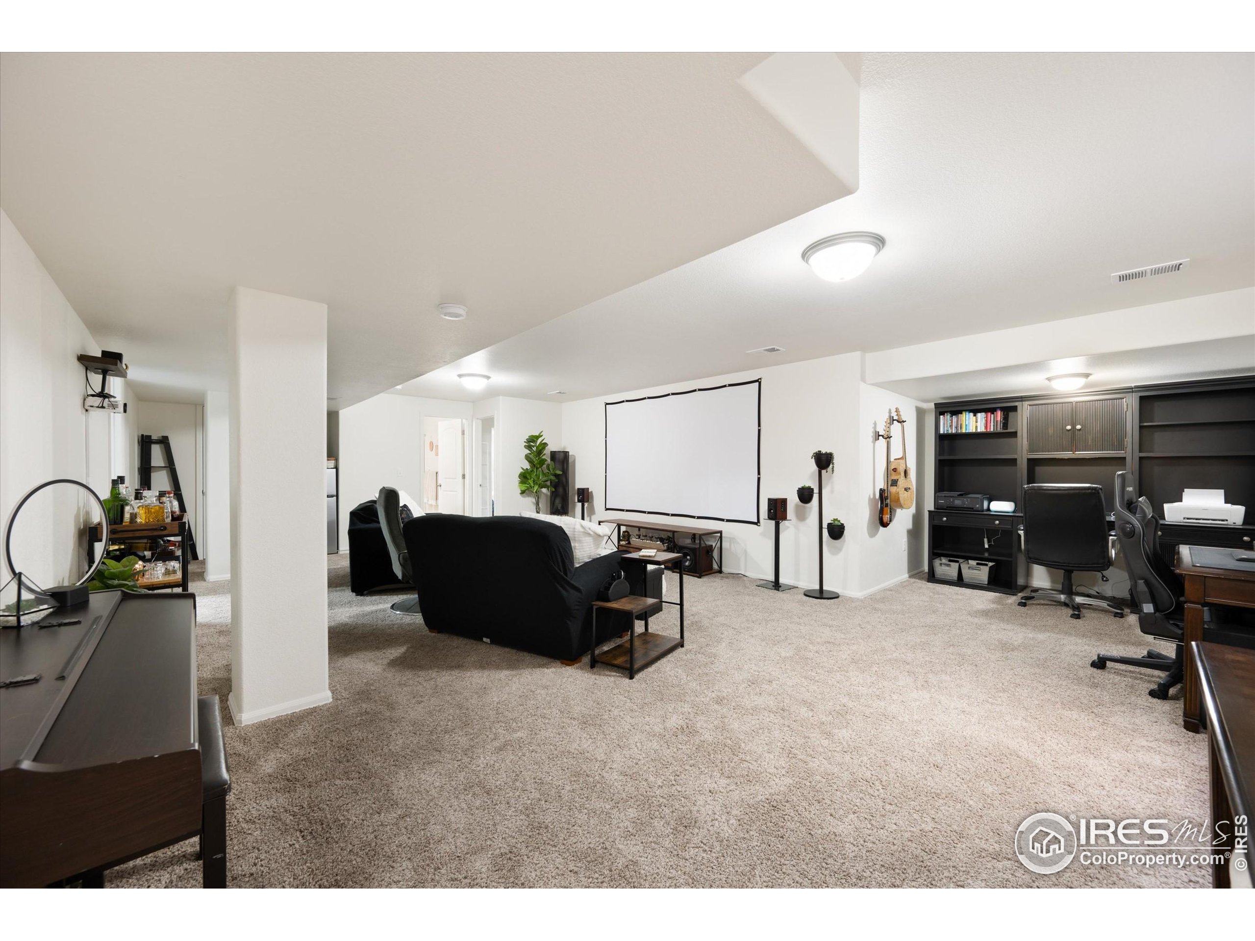 1995 Thundercloud Drive Windsor, CO 80550 - Photo 16 of 36 a living room with furniture and a gym machine