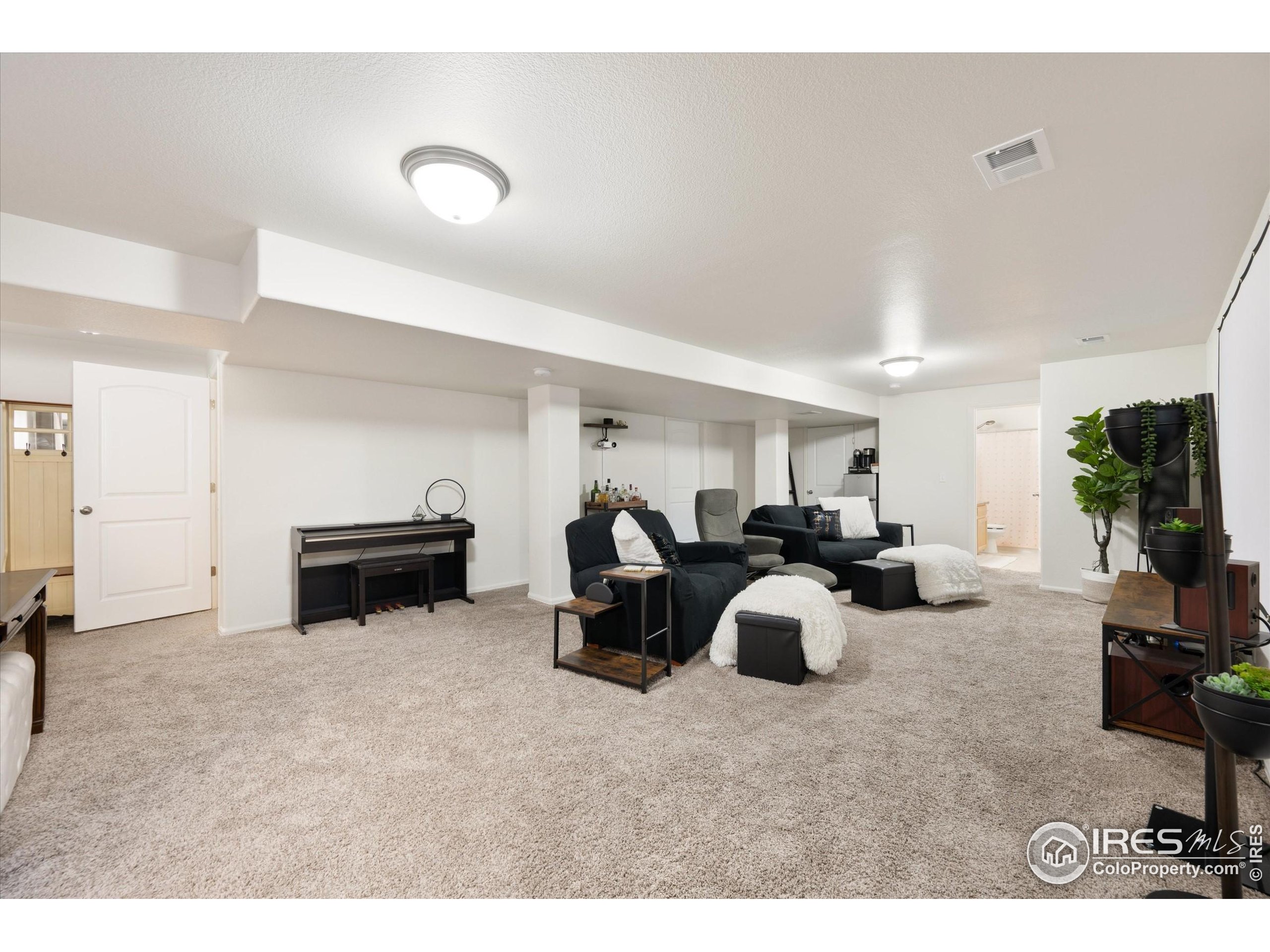 1995 Thundercloud Drive Windsor, CO 80550 - Photo 17 of 36 a living room with furniture and a flat screen tv