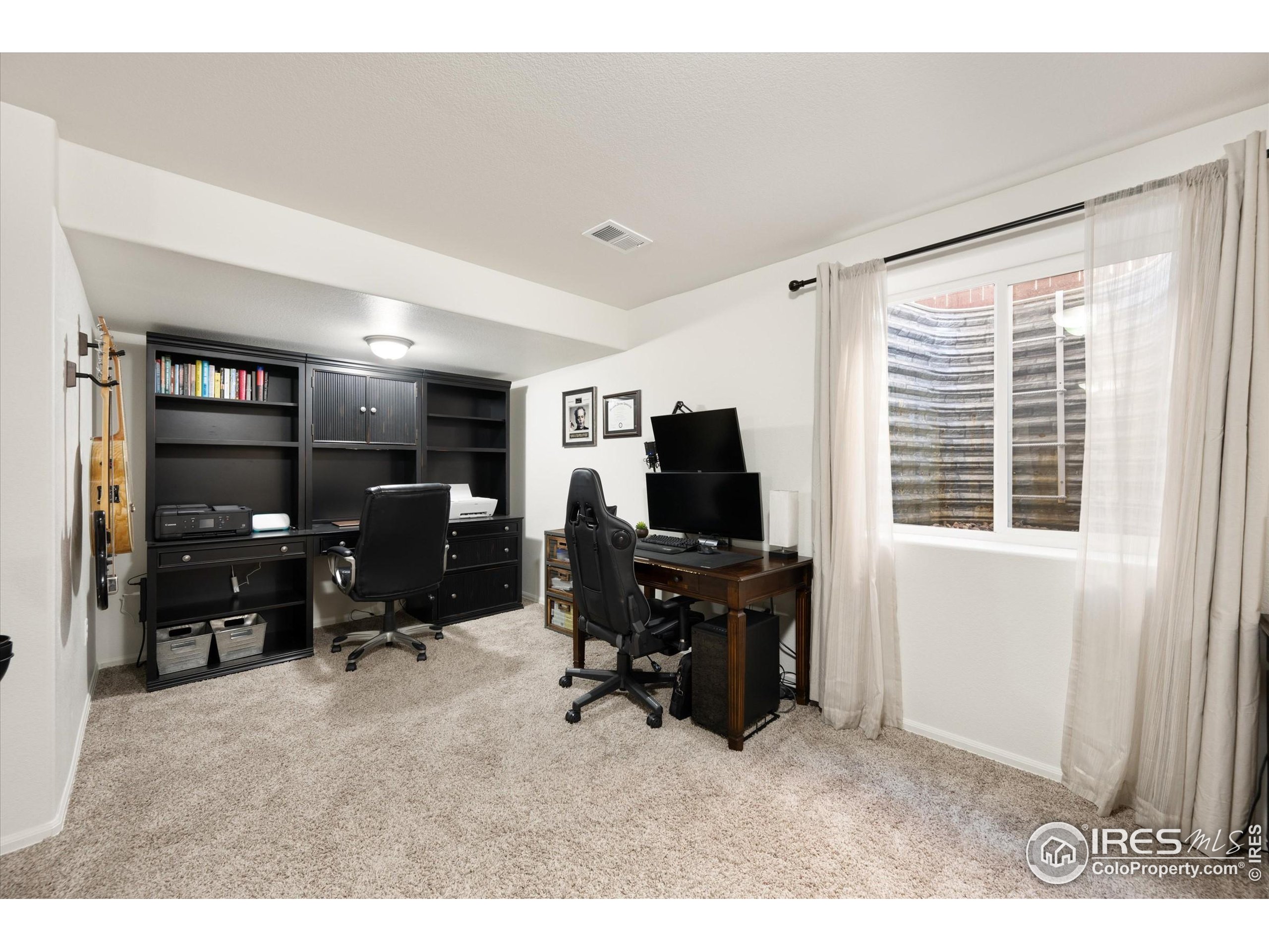 1995 Thundercloud Drive Windsor, CO 80550 - Photo 19 of 36 a view of a livingroom with furniture and a flat screen tv