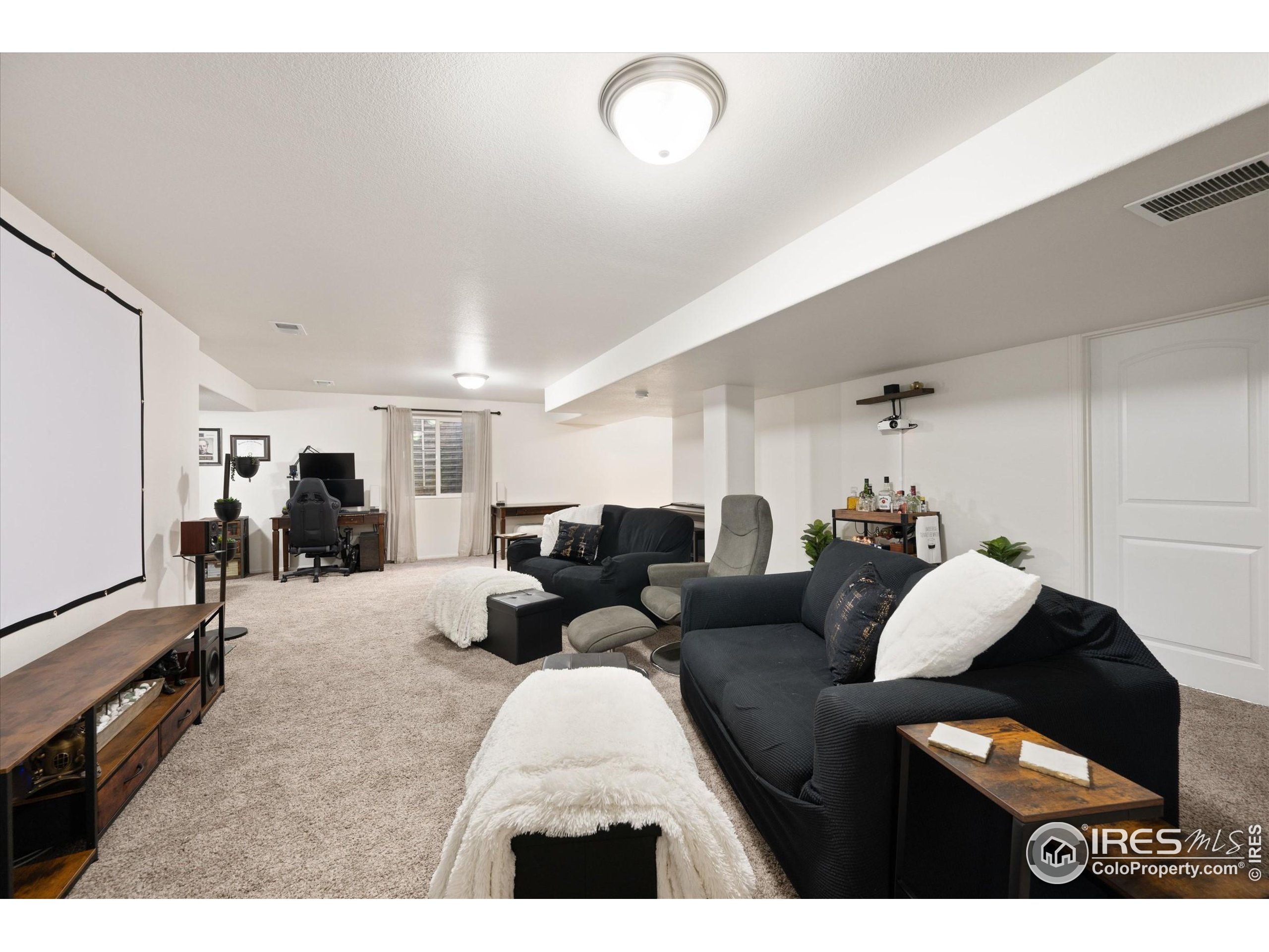 1995 Thundercloud Drive Windsor, CO 80550 - Photo 20 of 36 a living room with furniture and a gym machine