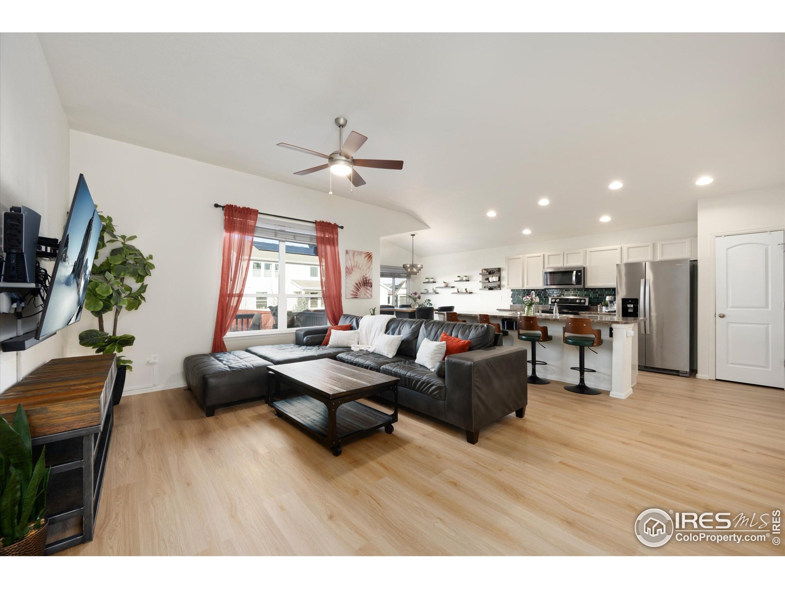 1995 Thundercloud Drive Windsor, CO 80550 - Photo 3 of 36 a living room with furniture kitchen view and a wooden floor