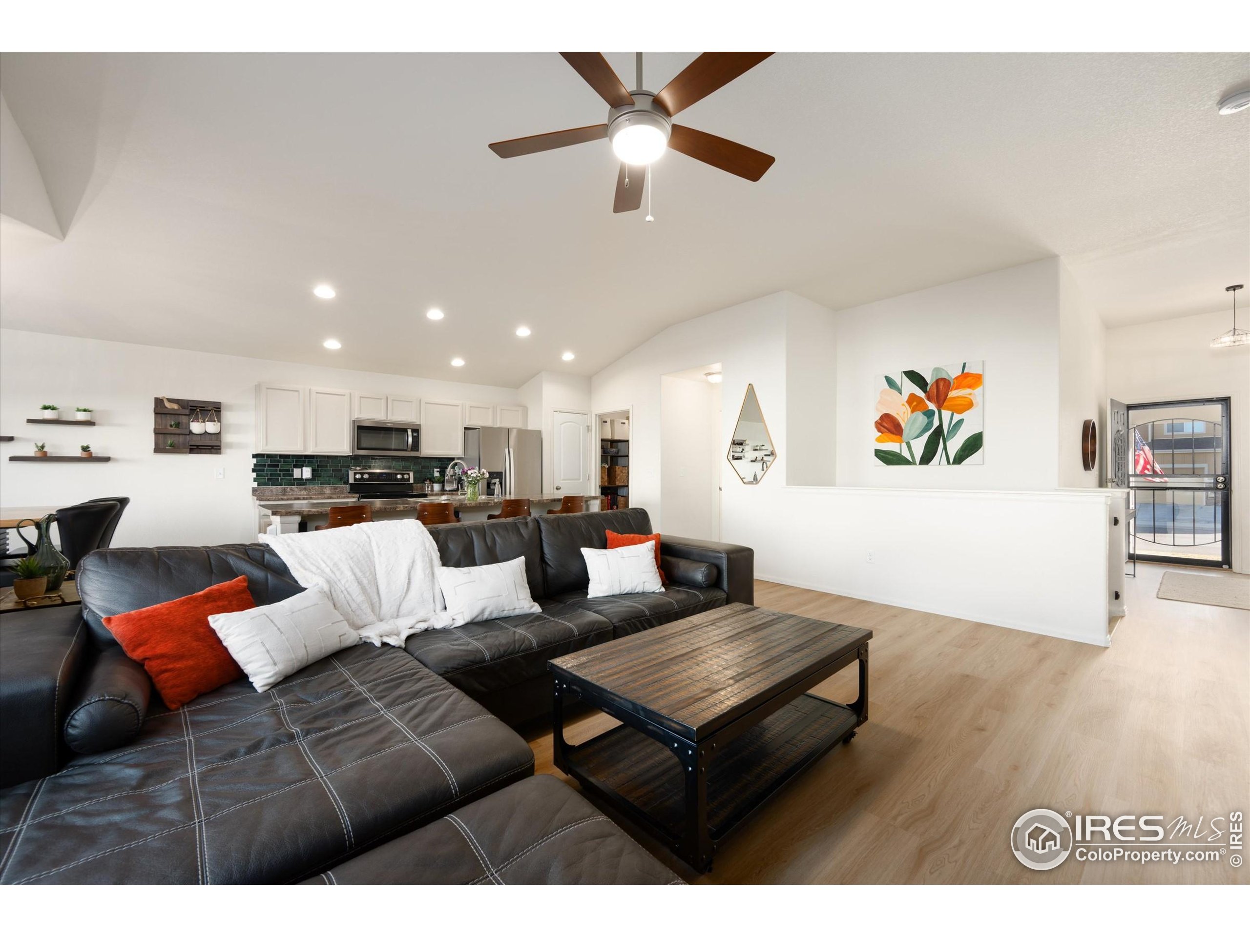 1995 Thundercloud Drive Windsor, CO 80550 - Photo 4 of 36 a living room with furniture and kitchen view