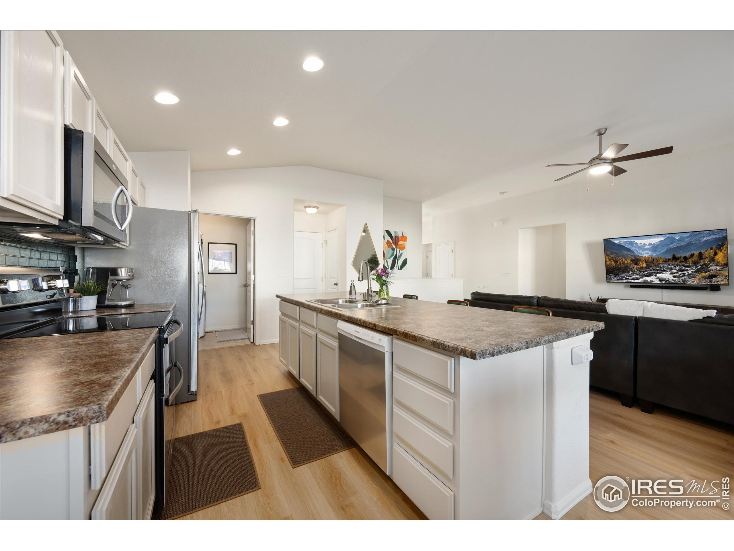 1995 Thundercloud Drive Windsor, CO 80550 - Photo 9 of 36 a kitchen with stainless steel appliances granite countertop a stove a sink and a refrigerator