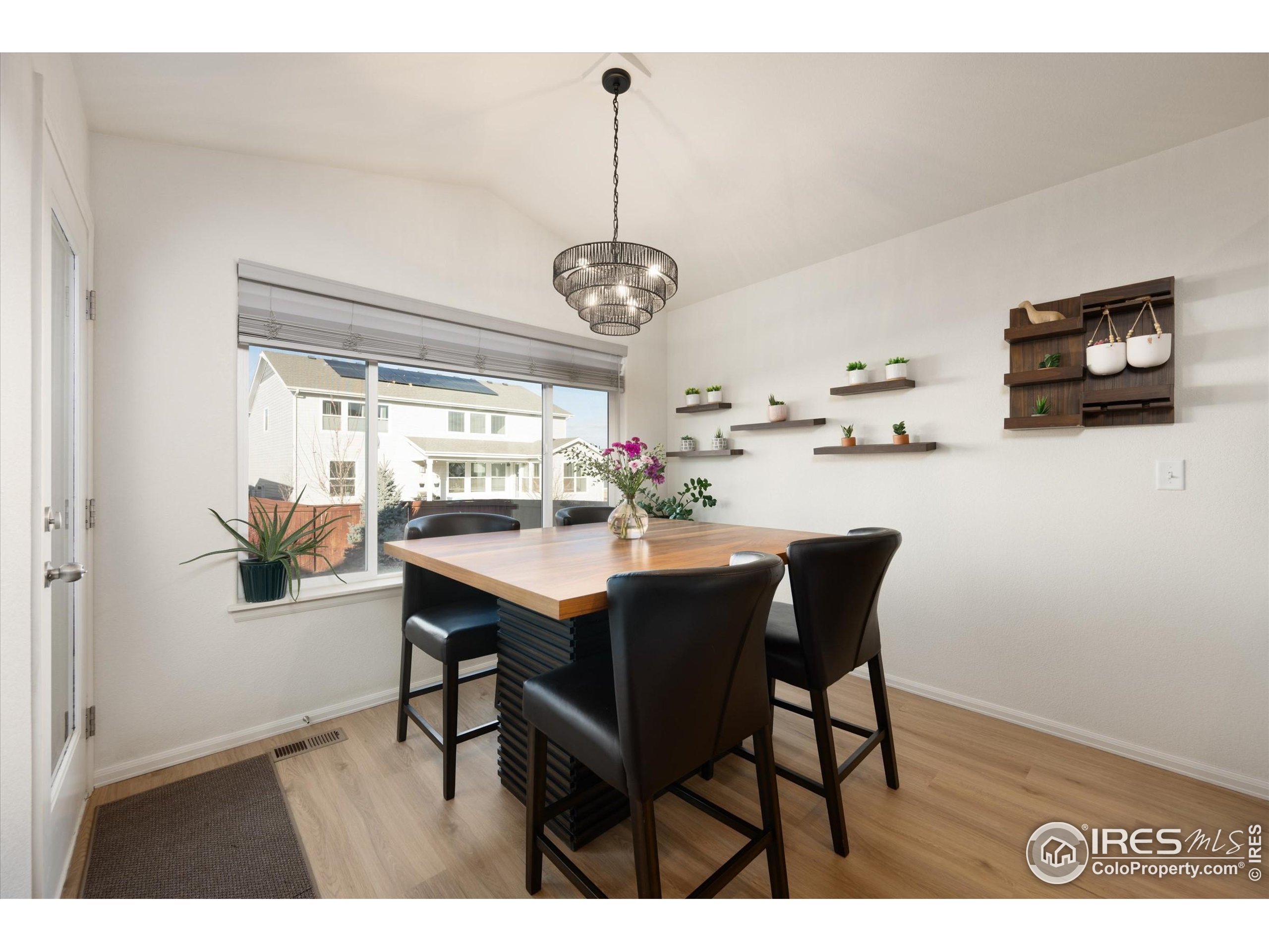 1995 Thundercloud Drive Windsor, CO 80550 - Photo 10 of 36 a view of a dining room with furniture window and wooden floor