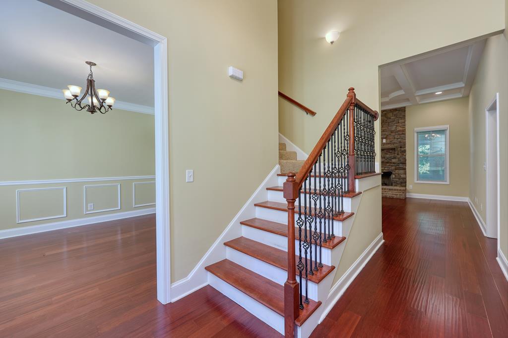 182 Oak Ridge Drive Waverly Hall, GA 31831 - Photo 16 of 40 a view of a hallway with wooden floor and staircase