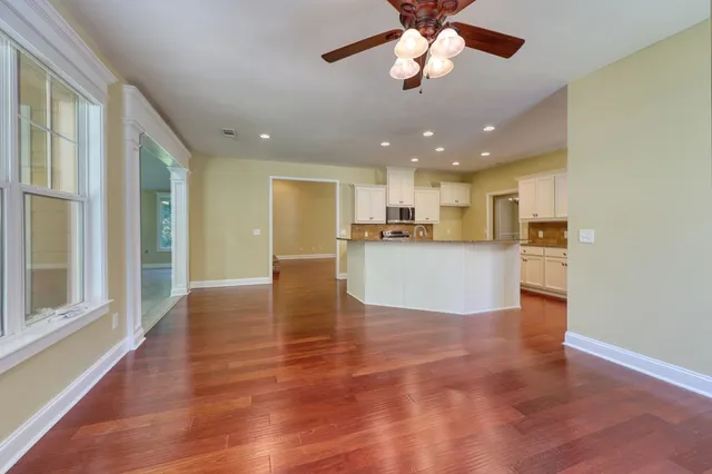 a view of kitchen with kitchen island wooden floor center island and appliances