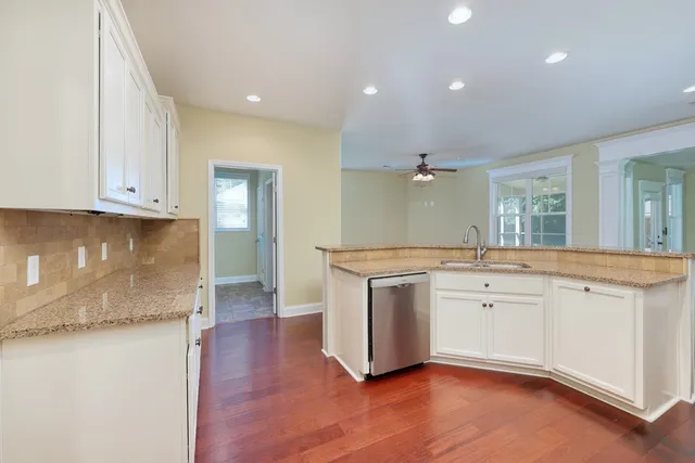 a spacious bathroom with a granite countertop sink and a mirror