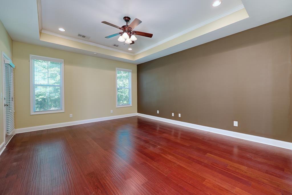 182 Oak Ridge Drive Waverly Hall, GA 31831 - Photo 28 of 40 an empty room with wooden floor and windows
