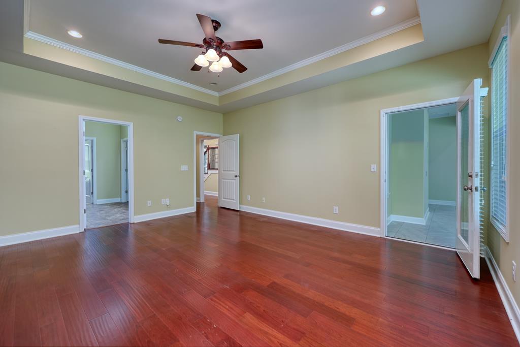 182 Oak Ridge Drive Waverly Hall, GA 31831 - Photo 29 of 40 a view of an empty room with wooden floor
