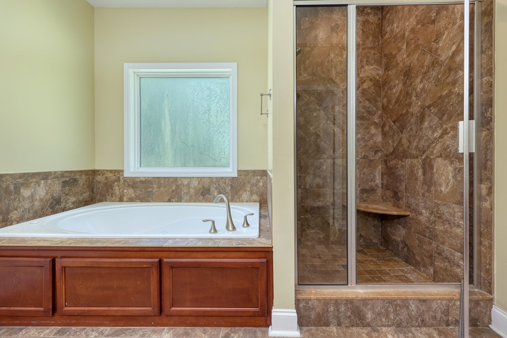 182 Oak Ridge Drive Waverly Hall, GA 31831 - Photo 31 of 40 a bathroom with a bathtub and shower