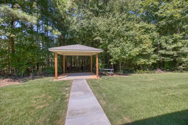 a view of a table and chairs in backyard of the house