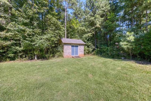 a view of a yard with a house and a trees