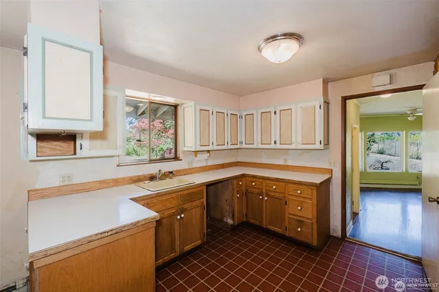 a kitchen with a sink and a stove top oven