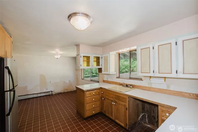 a kitchen with sink cabinets and window
