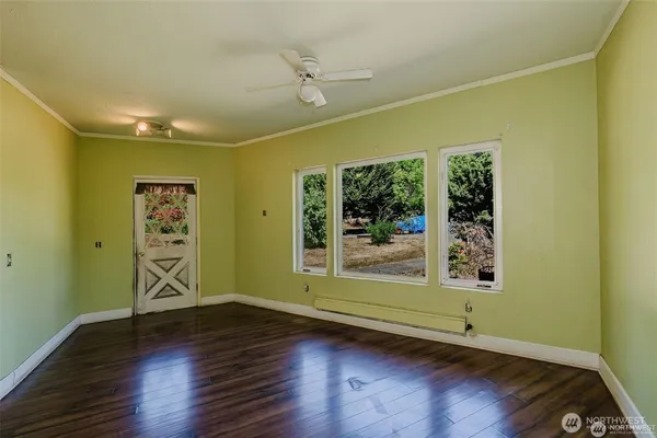 a view of room with window and wooden floor