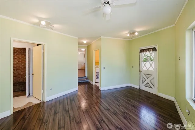 a view of an empty room with wooden floor