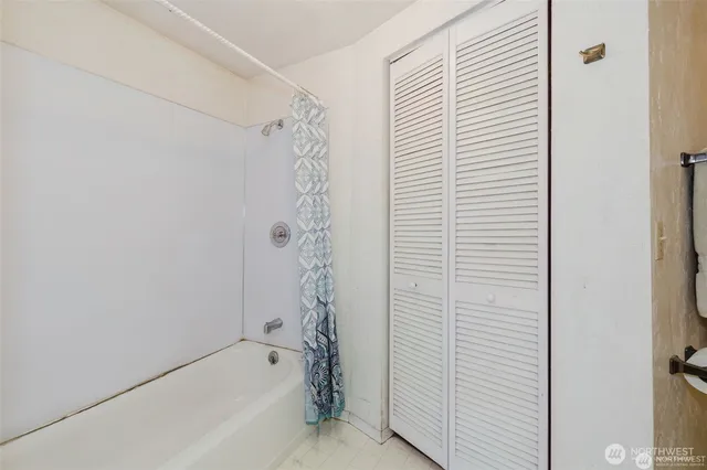 a bathroom with a bathtub and shower