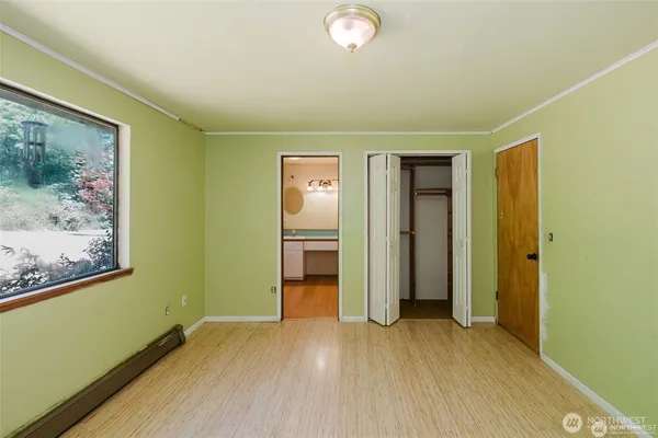 a view of a big room with wooden floor and closet