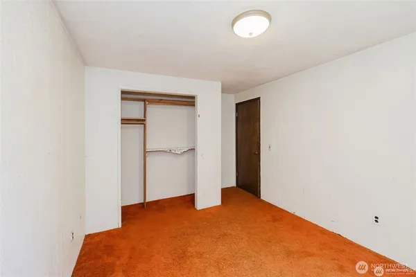 a bedroom with a bed and a table