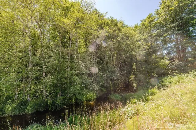 a view of balcony with wooden floor and fence