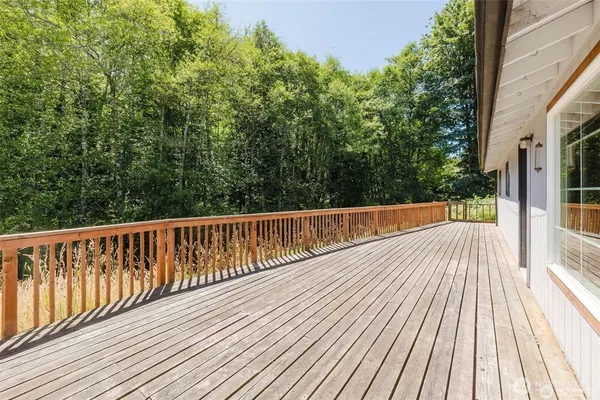 a backyard of a house with barbeque oven table and chairs