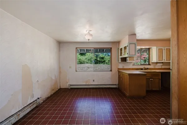 a view of a kitchen with a sink and dishwasher with wooden floor