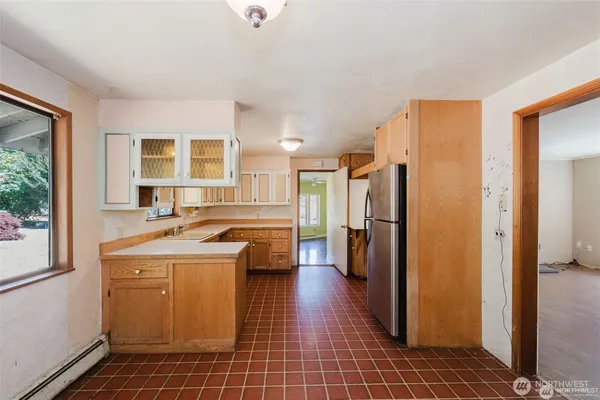 a view of a kitchen with a sink and a refrigerator