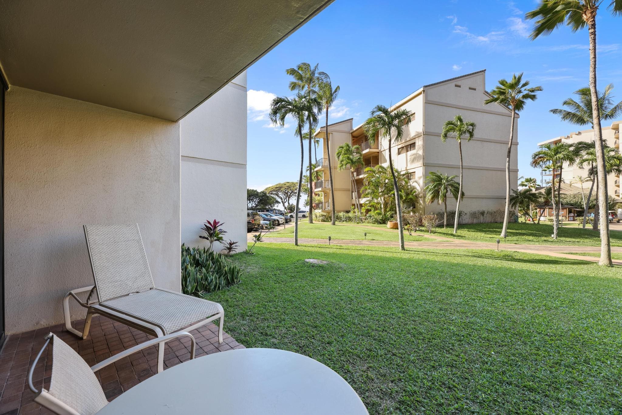 3445 Lower Honoapiilani Road, Unit 151 Lahaina, HI 96761 - Photo 22 of 42 a view of a chair and table in the garden