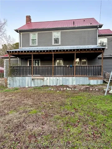 a view of backyard with tub and wooden fence
