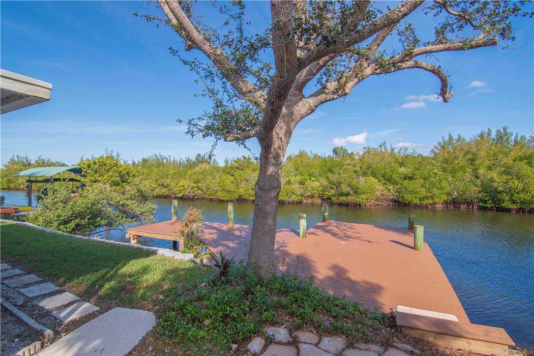 922 Jackson Way Fort Pierce, FL 34949 - Photo 2 of 34 a view of a lake with houses in the back