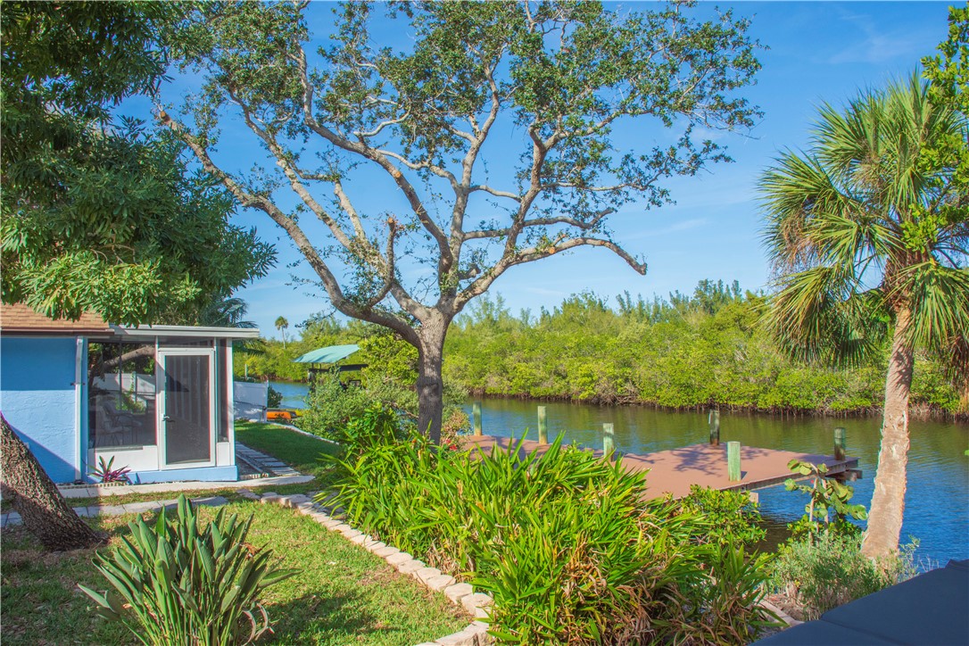 922 Jackson Way Fort Pierce, FL 34949 - Photo 28 of 34 a view of a garden with plants and a large tree