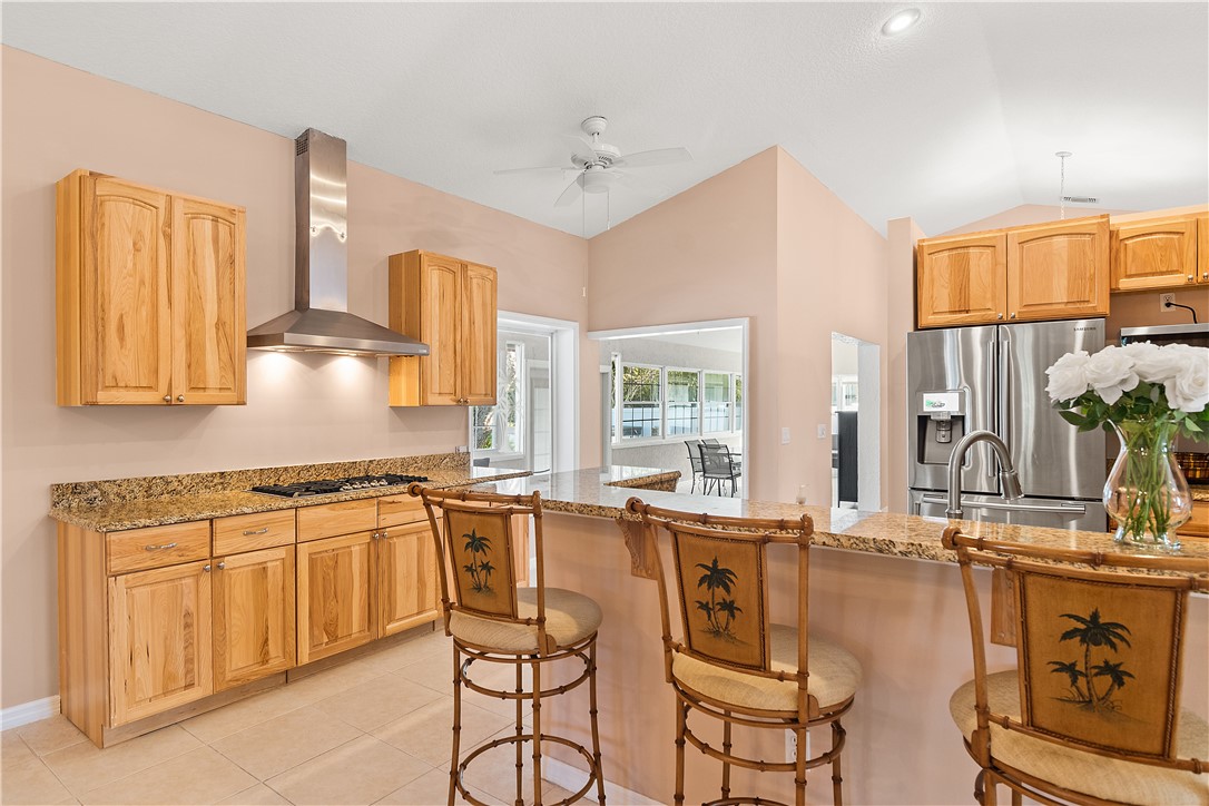 922 Jackson Way Fort Pierce, FL 34949 - Photo 7 of 34 a view of a kitchen with kitchen island granite countertop a large window cabinets and stainless steel appliances
