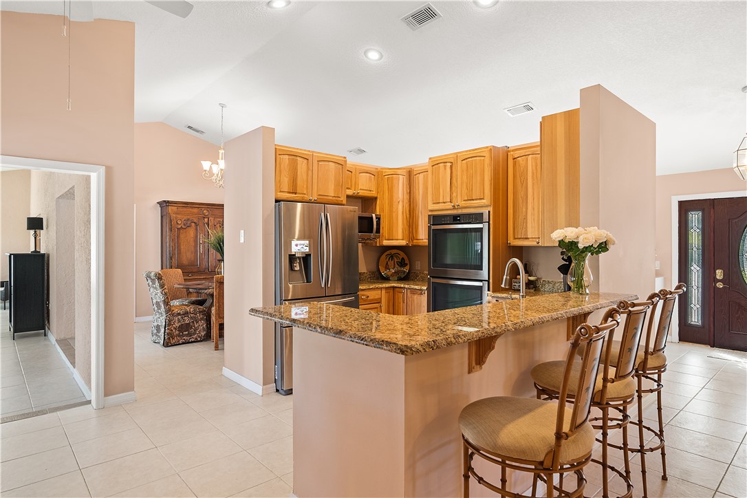 922 Jackson Way Fort Pierce, FL 34949 - Photo 8 of 34 a kitchen with stainless steel appliances granite countertop a refrigerator and microwave