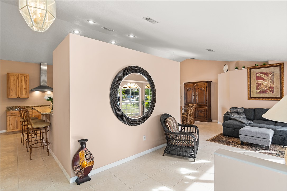 922 Jackson Way Fort Pierce, FL 34949 - Photo 10 of 34 a living room with furniture a window and a chandelier