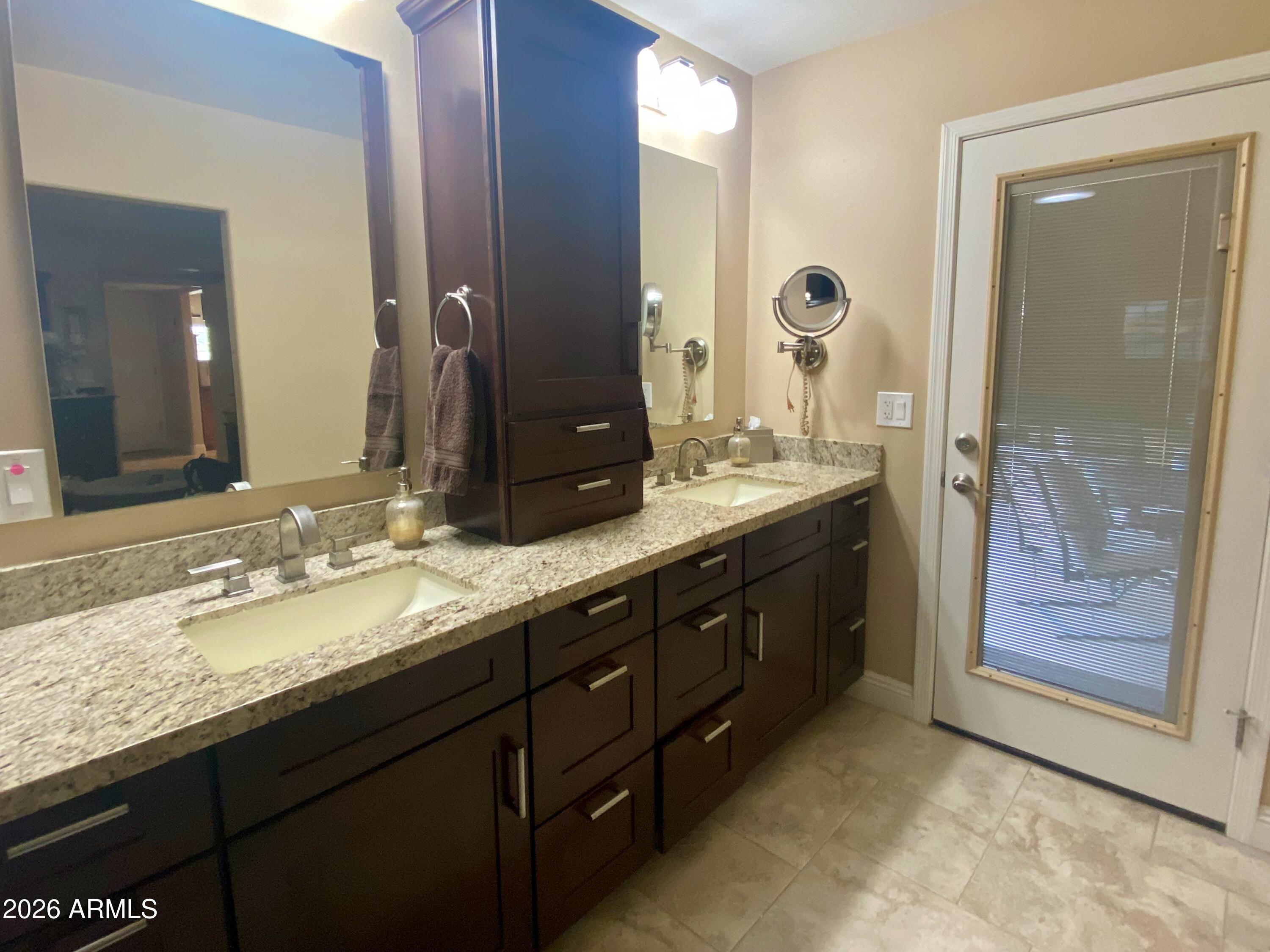 5610 East Justine Road Scottsdale, AZ 85254 - Photo 13 of 28 a bathroom with a granite countertop sink a large mirror and a shower