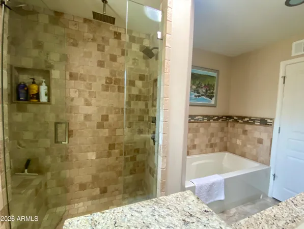 a bathroom with a bathtub and shower