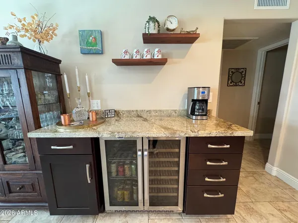 a bathroom with a granite countertop sink a mirror and vanity