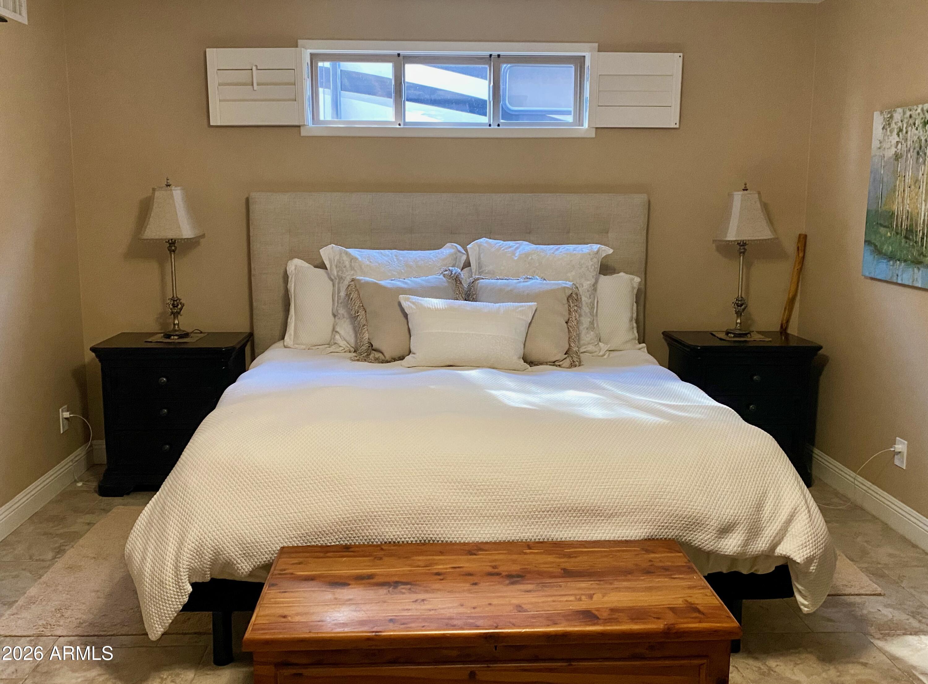 5610 East Justine Road Scottsdale, AZ 85254 - Photo 9 of 28 a large bed sitting in a bedroom next to a window