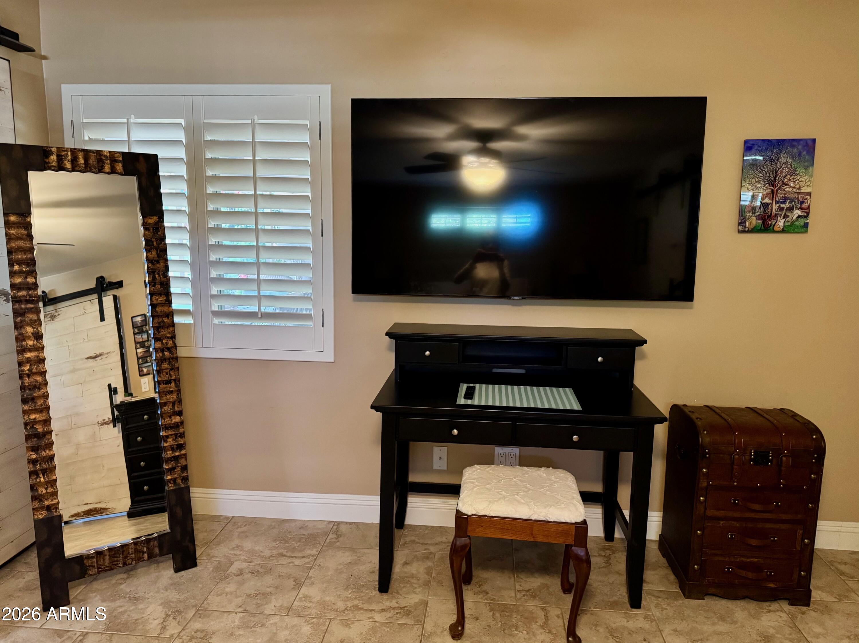 5610 East Justine Road Scottsdale, AZ 85254 - Photo 10 of 28 a living room with furniture and a flat screen tv